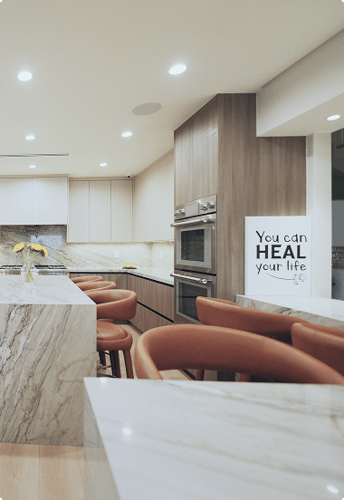 Modern kitchen with marble countertop and a motivating wall sign