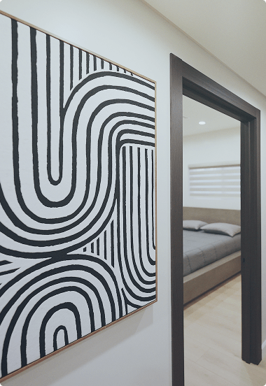Cozy rehab bedroom with a neatly made bed and a colorful painting on the wall