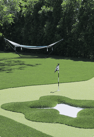 Expansive golf course featuring a central hole surrounded by vibrant greenery