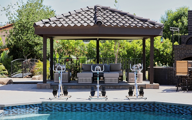outdoor poolside gazebo and exercise bikes, highlighting wellness activities in residential treatment